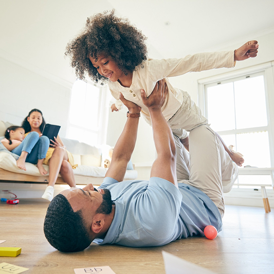family on living room floor playing